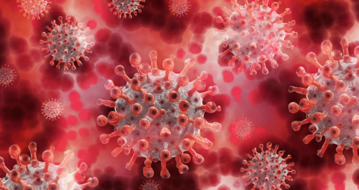 Mehrere Coronaviren schweben in roter Umgebung